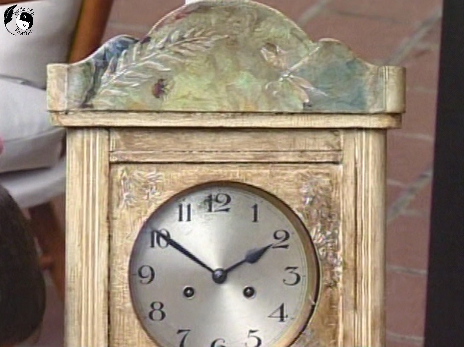 Top of decoupage wall clock showing decoupage on wood with peony, ladybug and added elements like dragonfly and leaf using texture paste