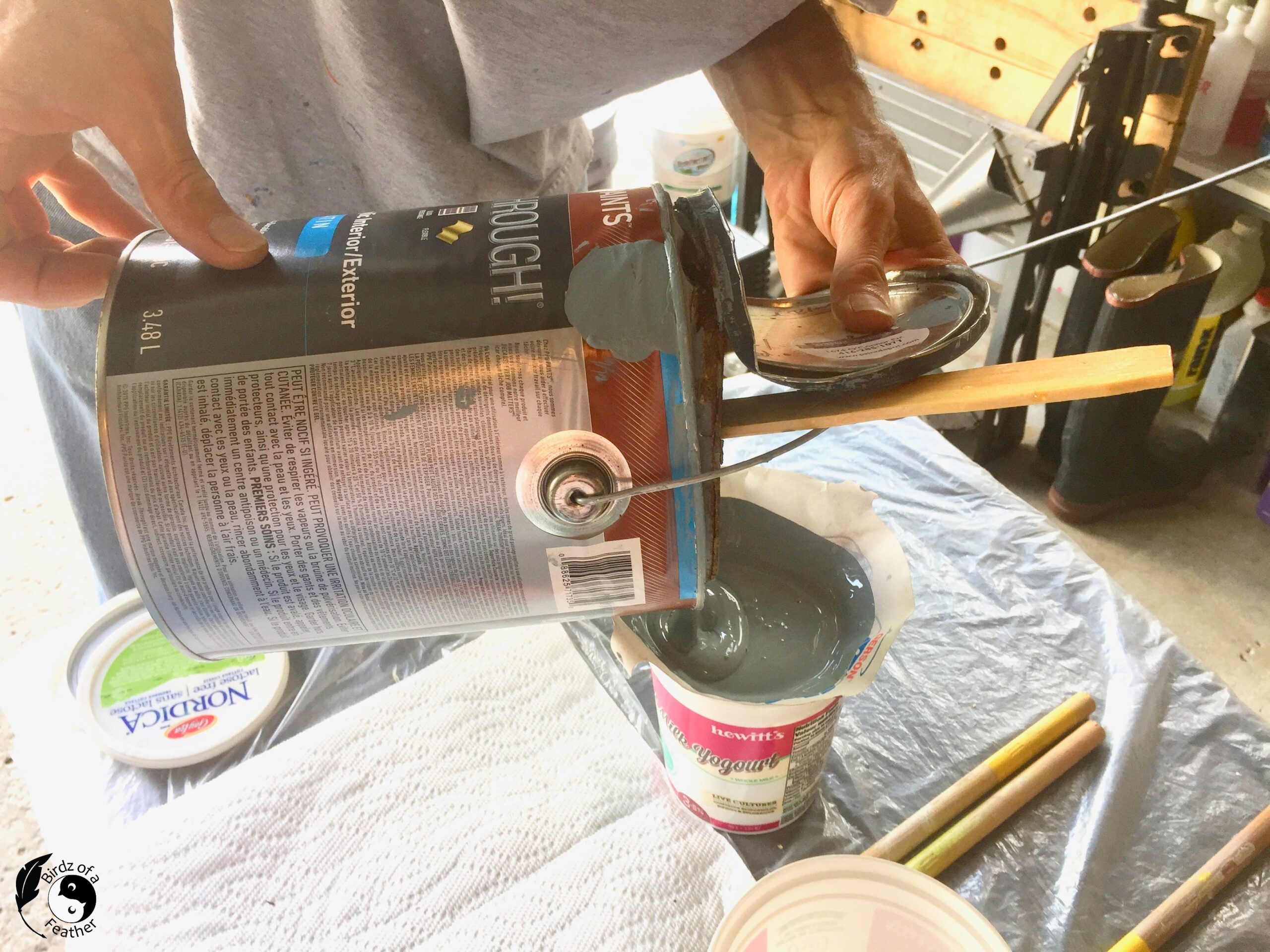 Pouring paint through a filter to prepare for Paint Using a Spray Gun