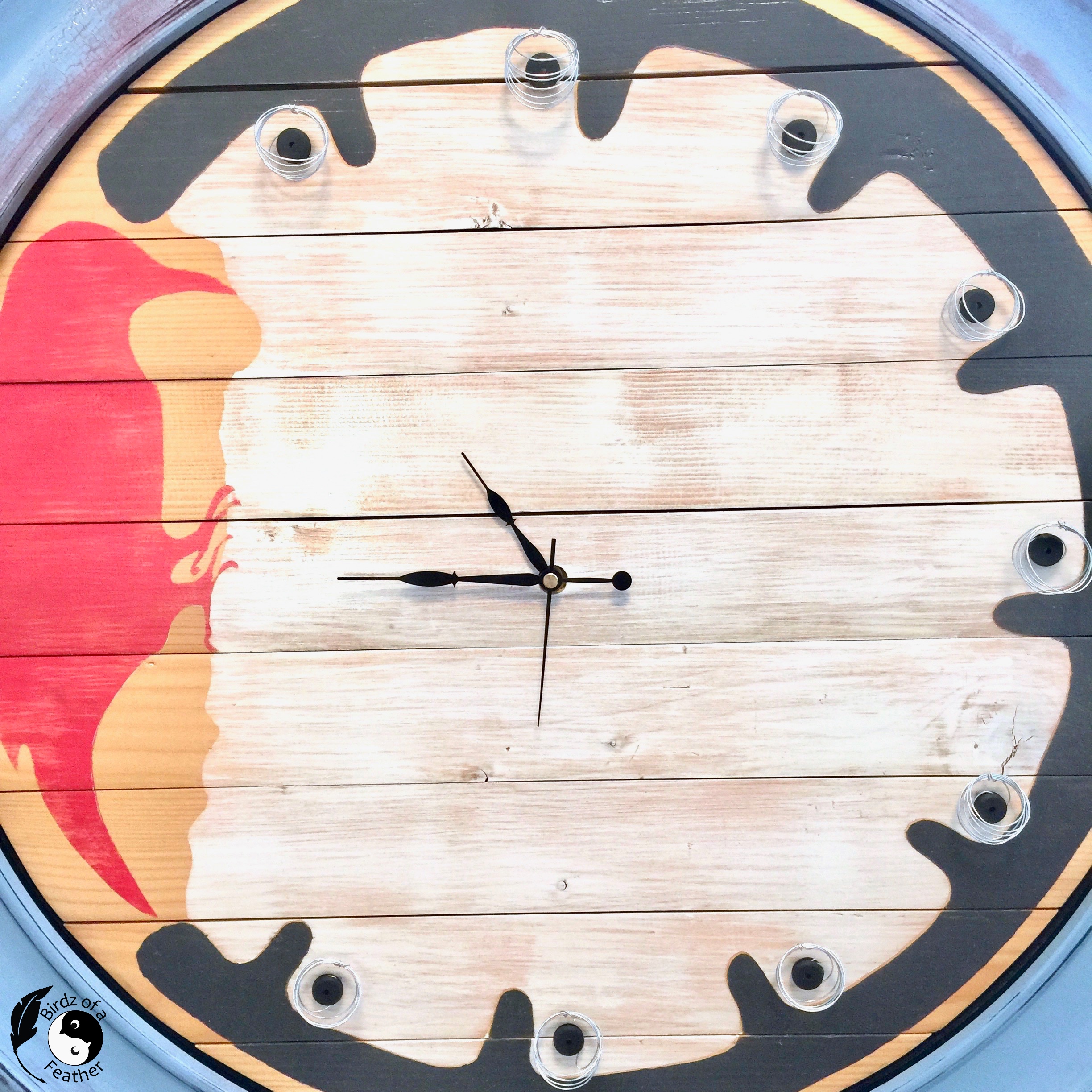 9 unique air plant holders attached to wooden pallet clock