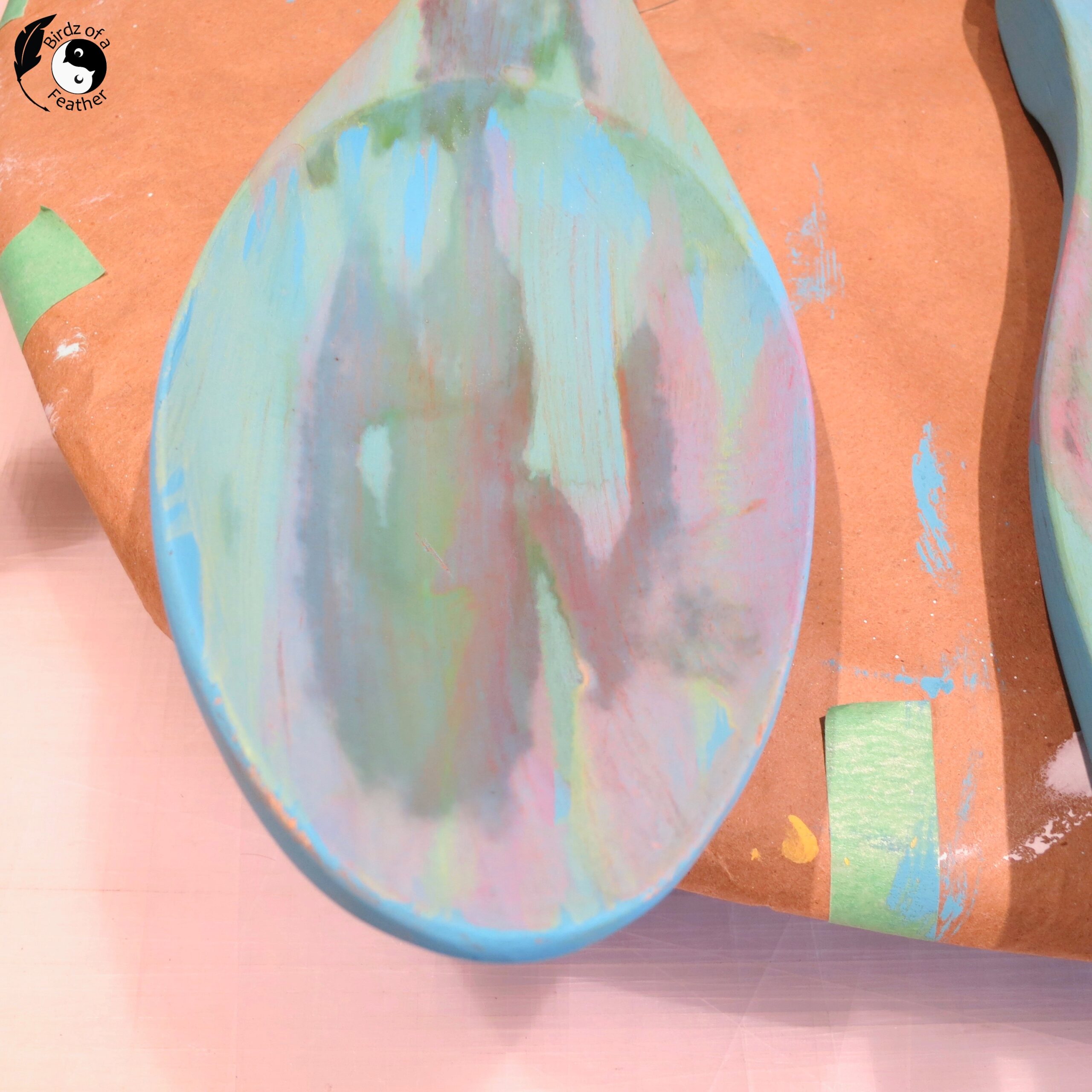 Closeup of clay paint on bowl of wooden spoon