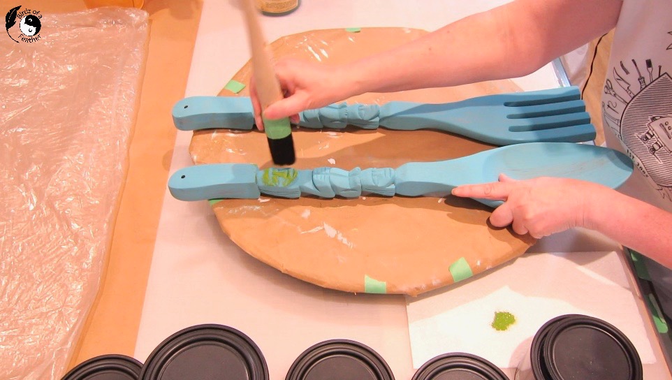 Dry brushing Pistachio clay paint onto tiki spoon