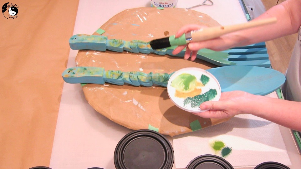 Variety of paint colour in white plastic lid acts as a pallet