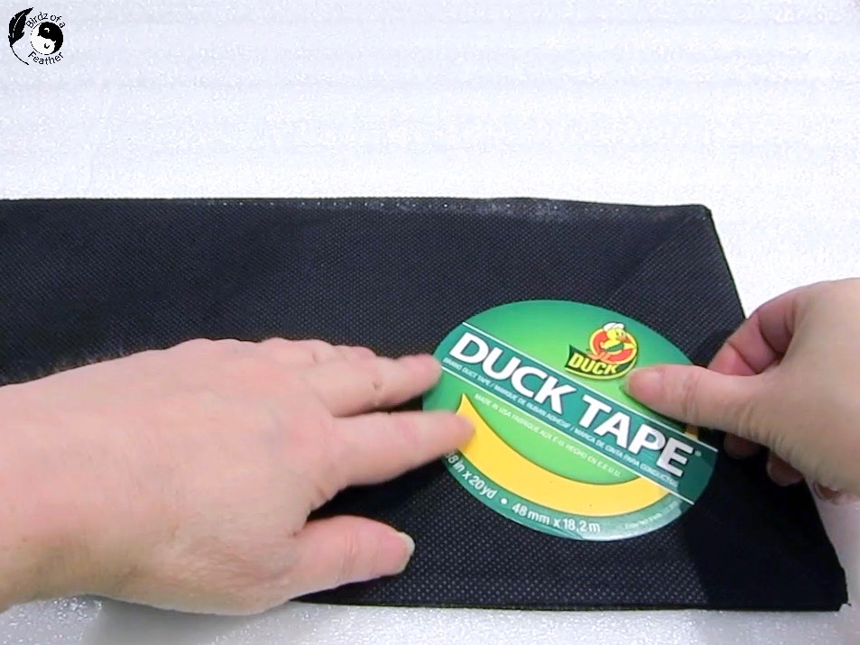 Using duck tape cardboard circle to trace bottom for sling water bottle bag