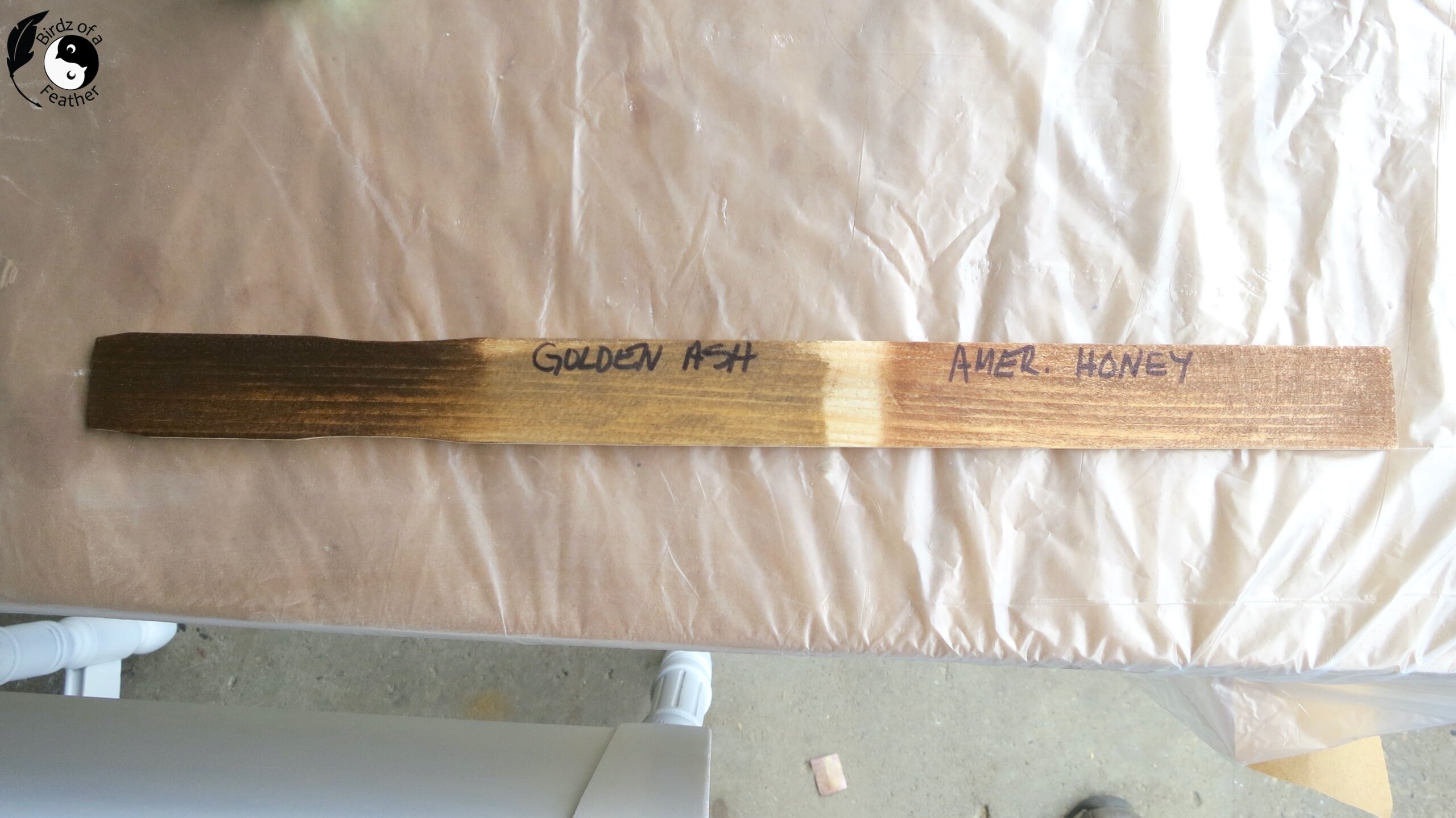 Third colour of stain added onto paint stick; from left is new colour, golden ash (not used) and American honey