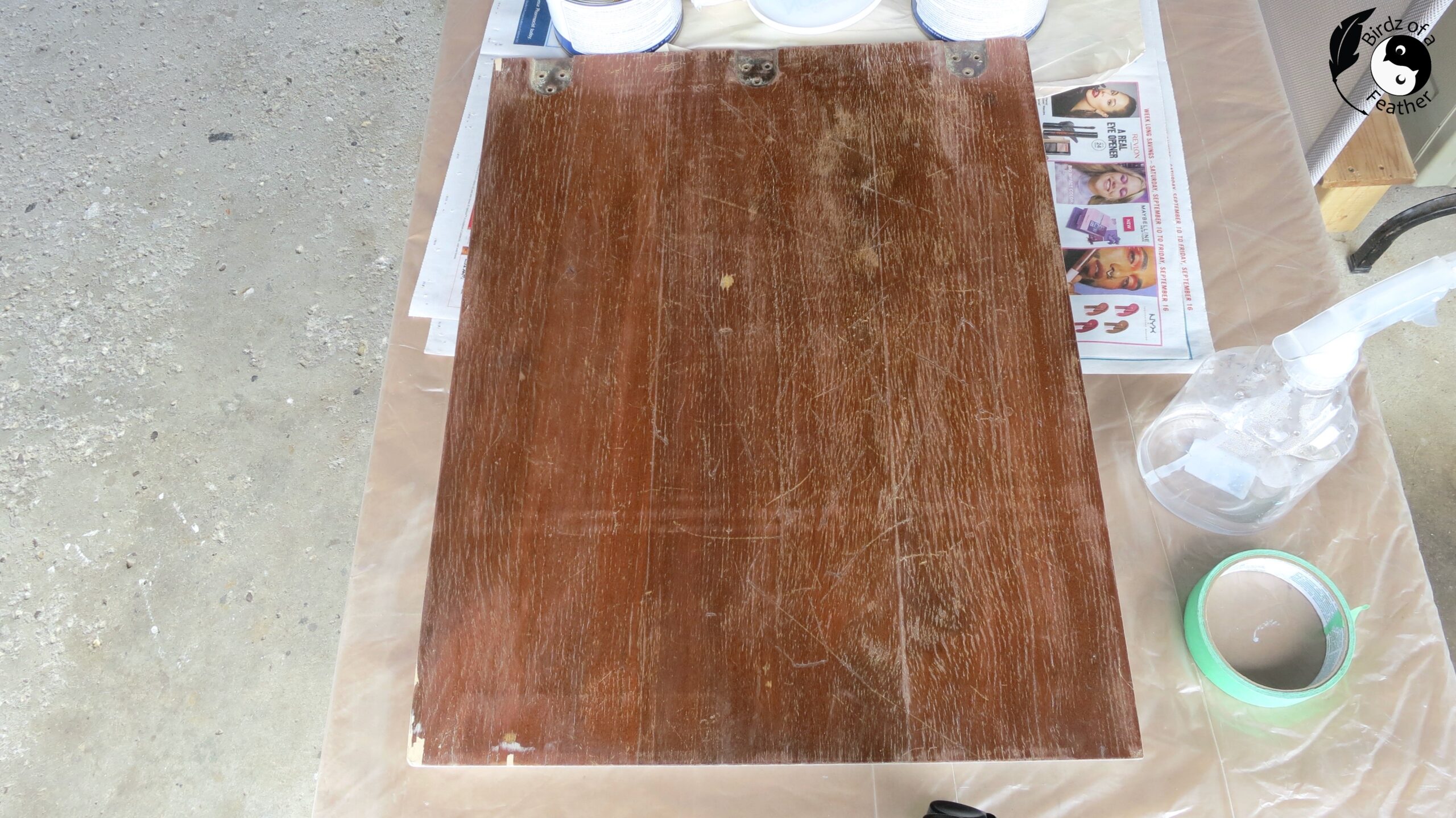 Inside lid of sewing table; scratched and damaged