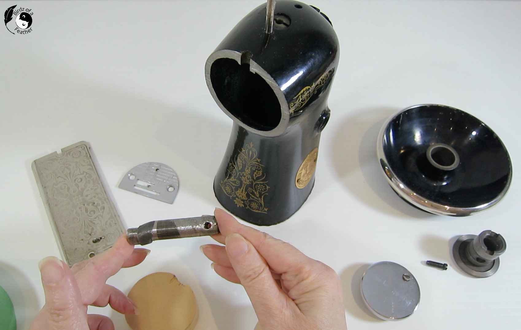 Hands holding cut metal shaft for right side of the DIY bookends