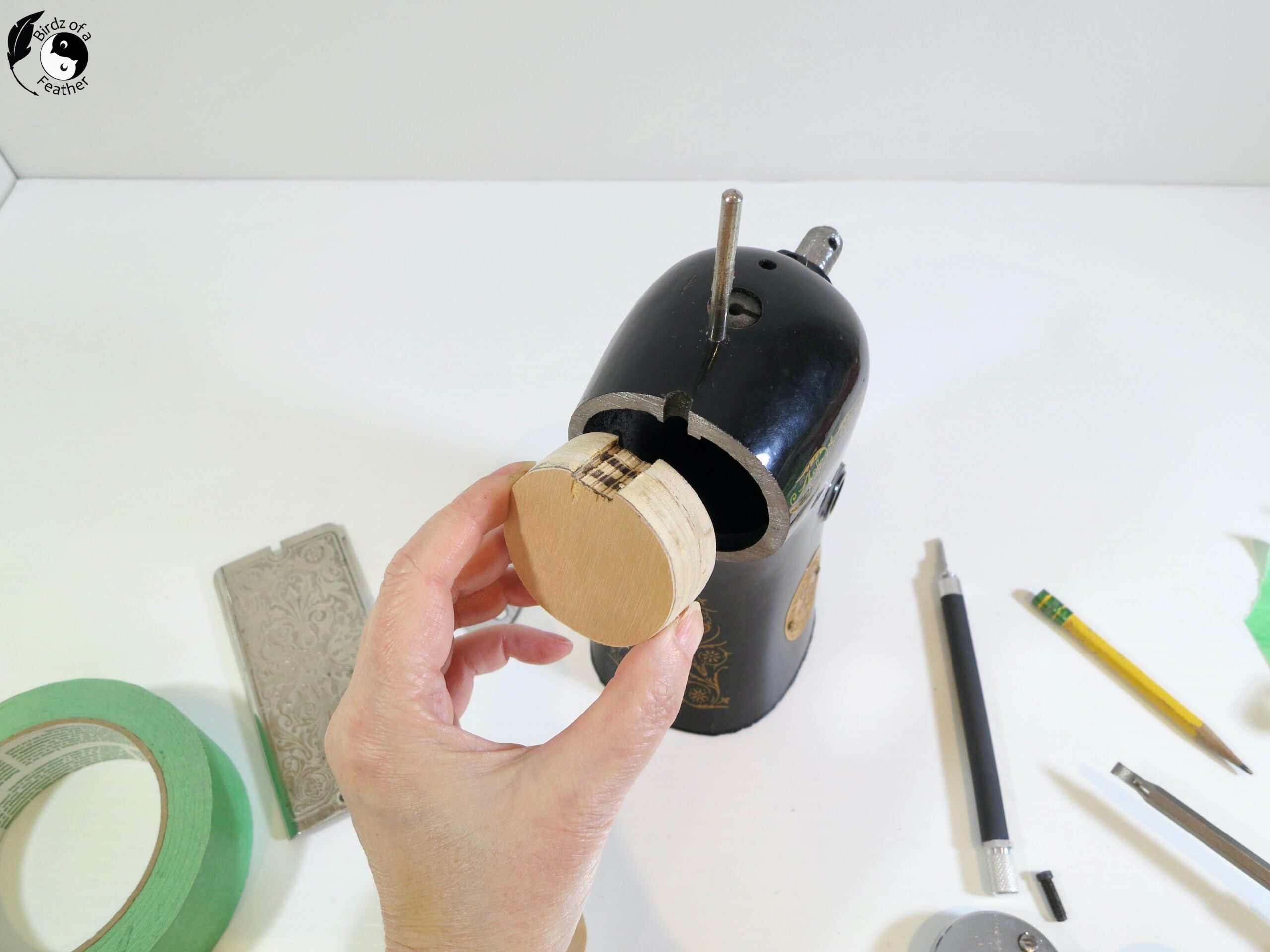 Hand putting the wood plug into right side of the cut sewing machine fro DIY bookends