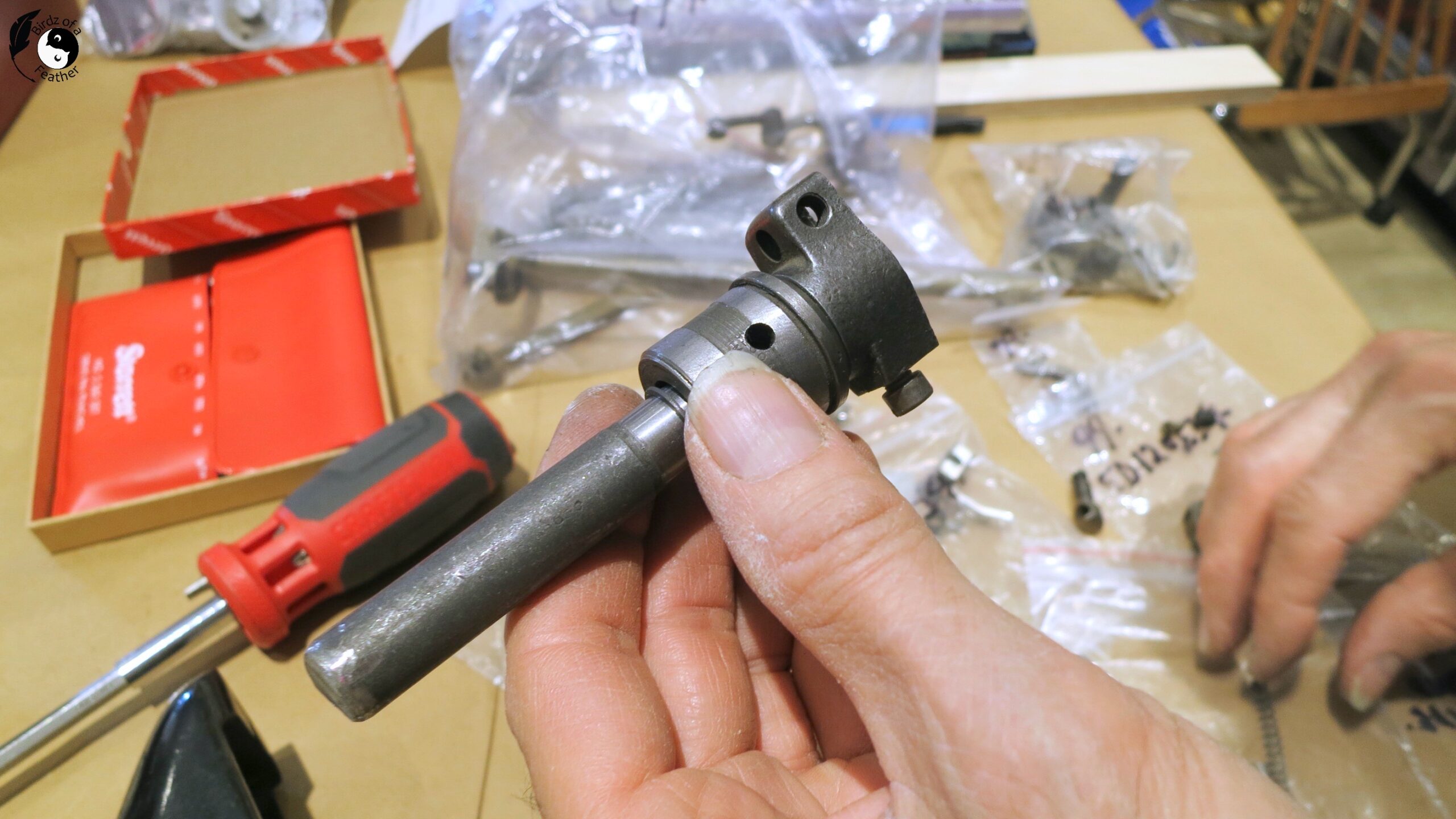 Hand holding left side of the metal shaft that has been cut for the DIY bookends