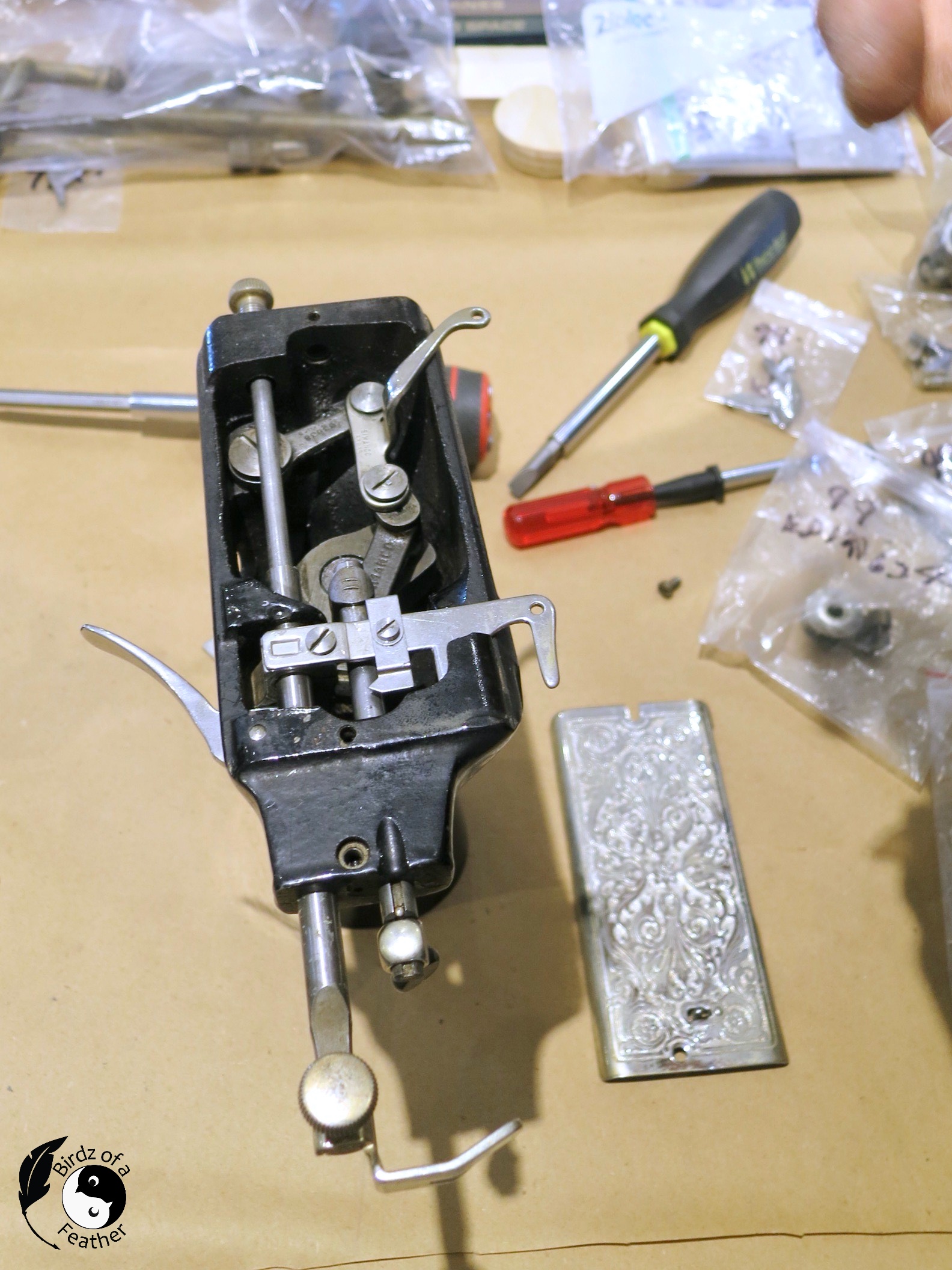 End of the sewing machine showing the inner workings of the needle assembly 