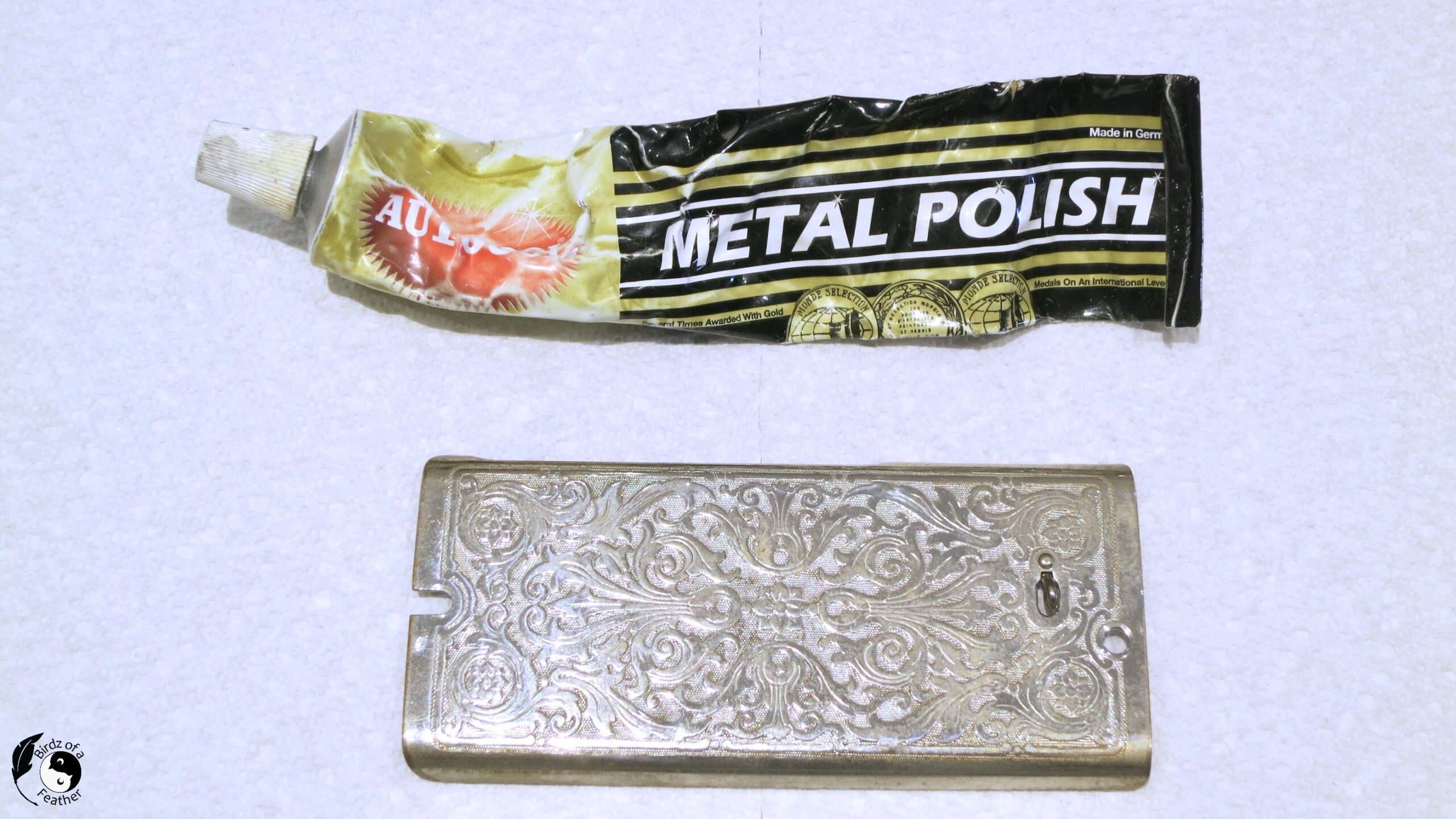Tube of Autosol metal polish with decorating silver sewing plate