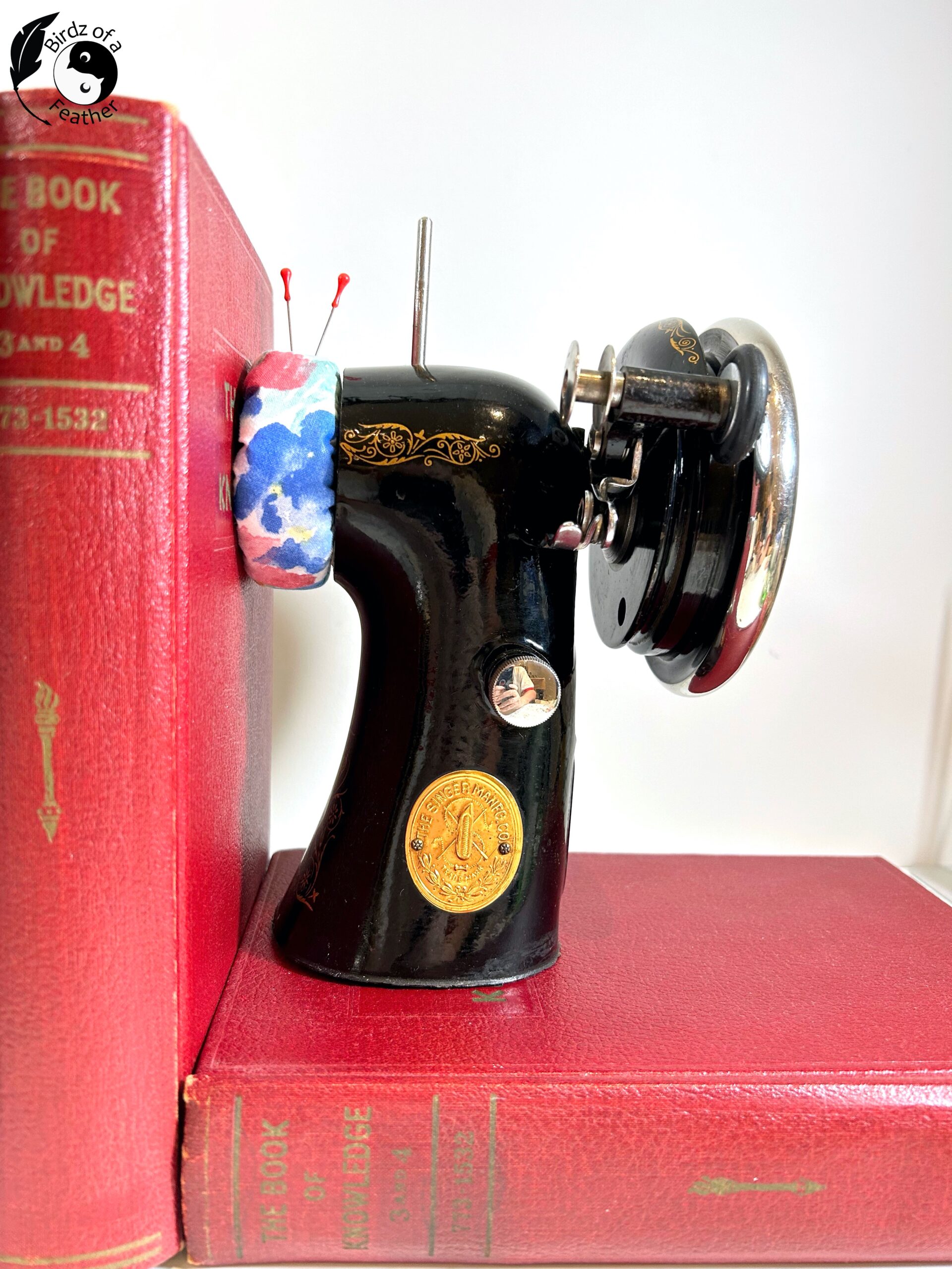 Right side of DIY bookends showing pin cushion with two red pin stuck in it