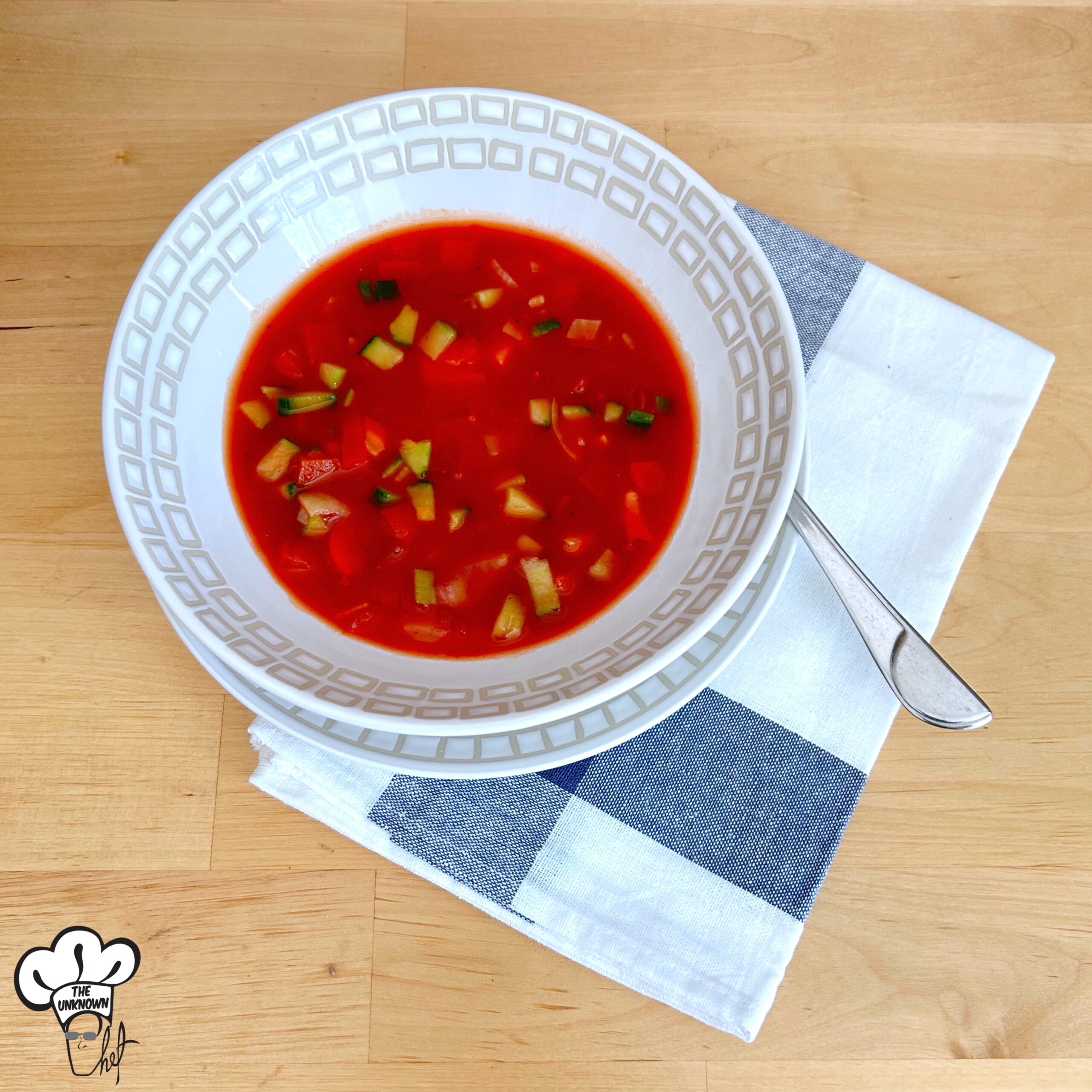 Gazpacho recipe served in a bowl on top of blue cotton napkin