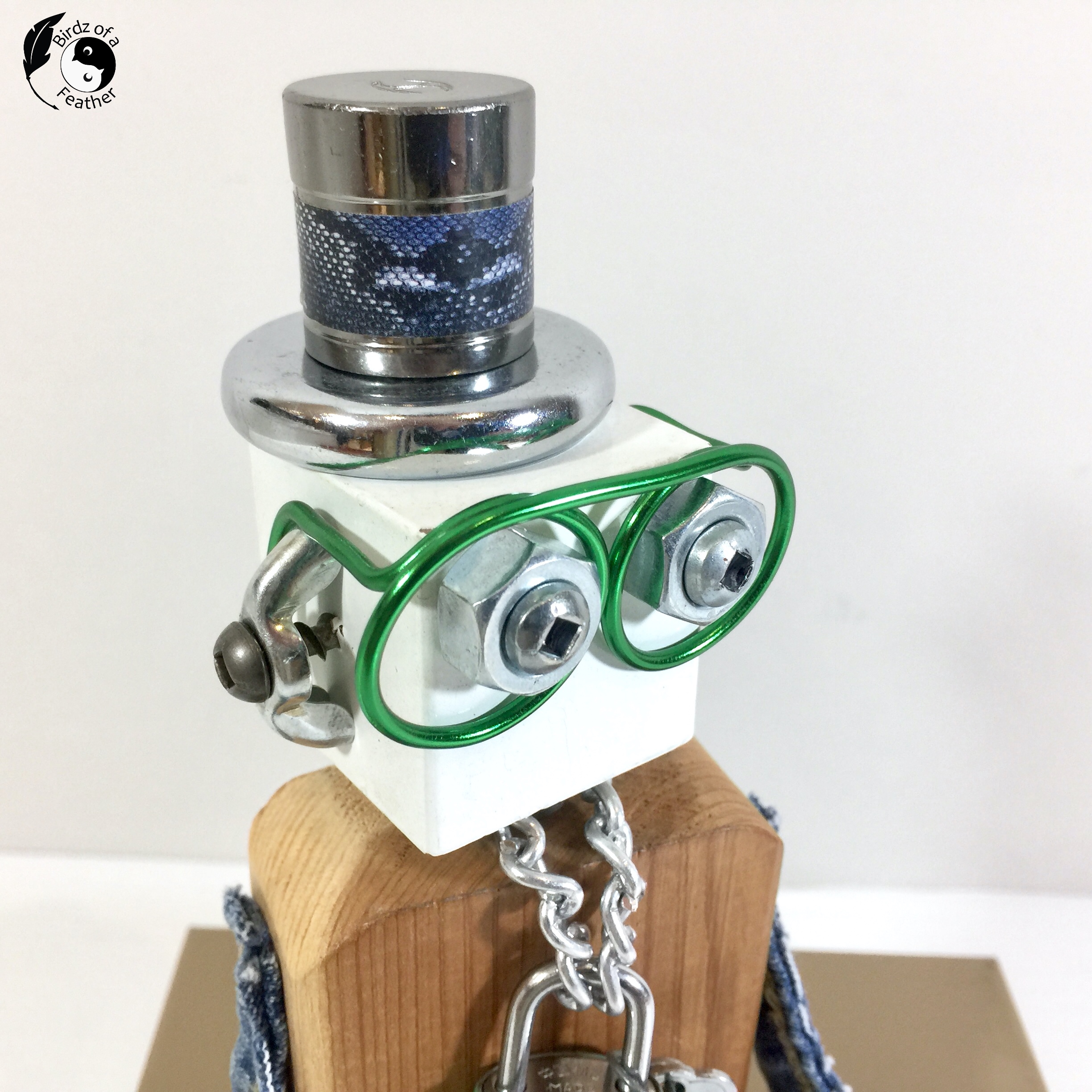 close up of scrap robot head showing glasses and top hat
