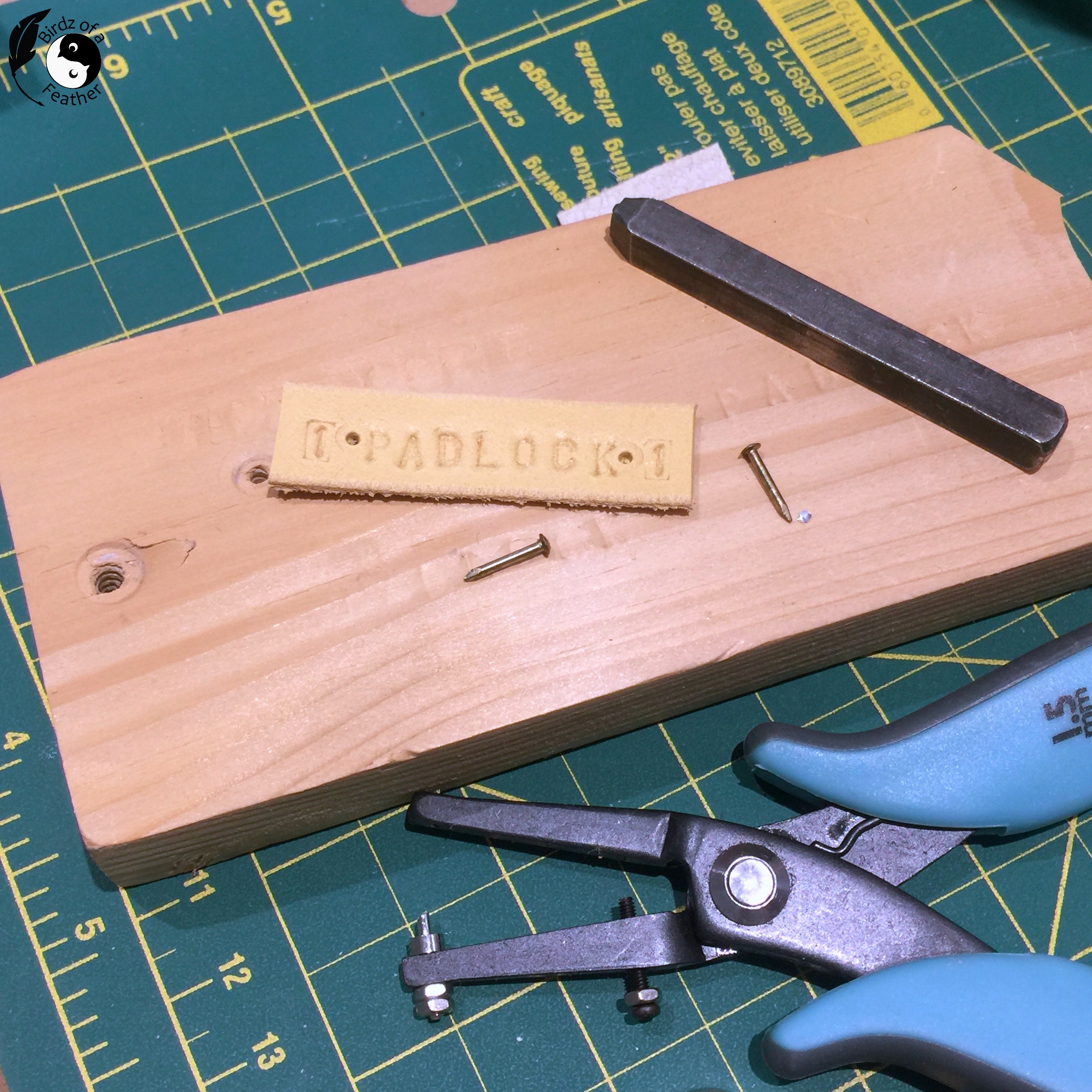 Leather scrap stamped with the name Padlock