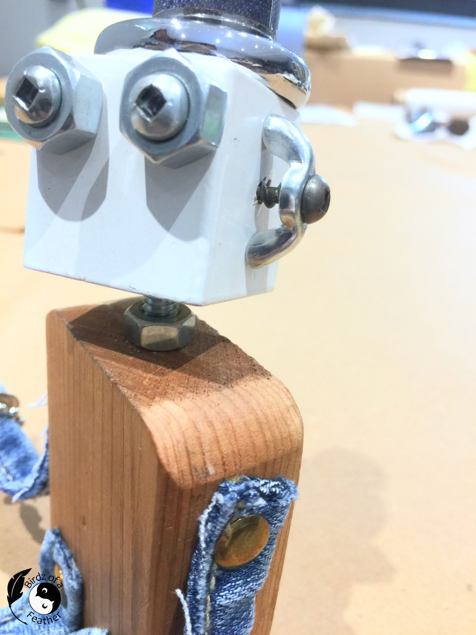 Close up of scrap robot head showing wing nut ears