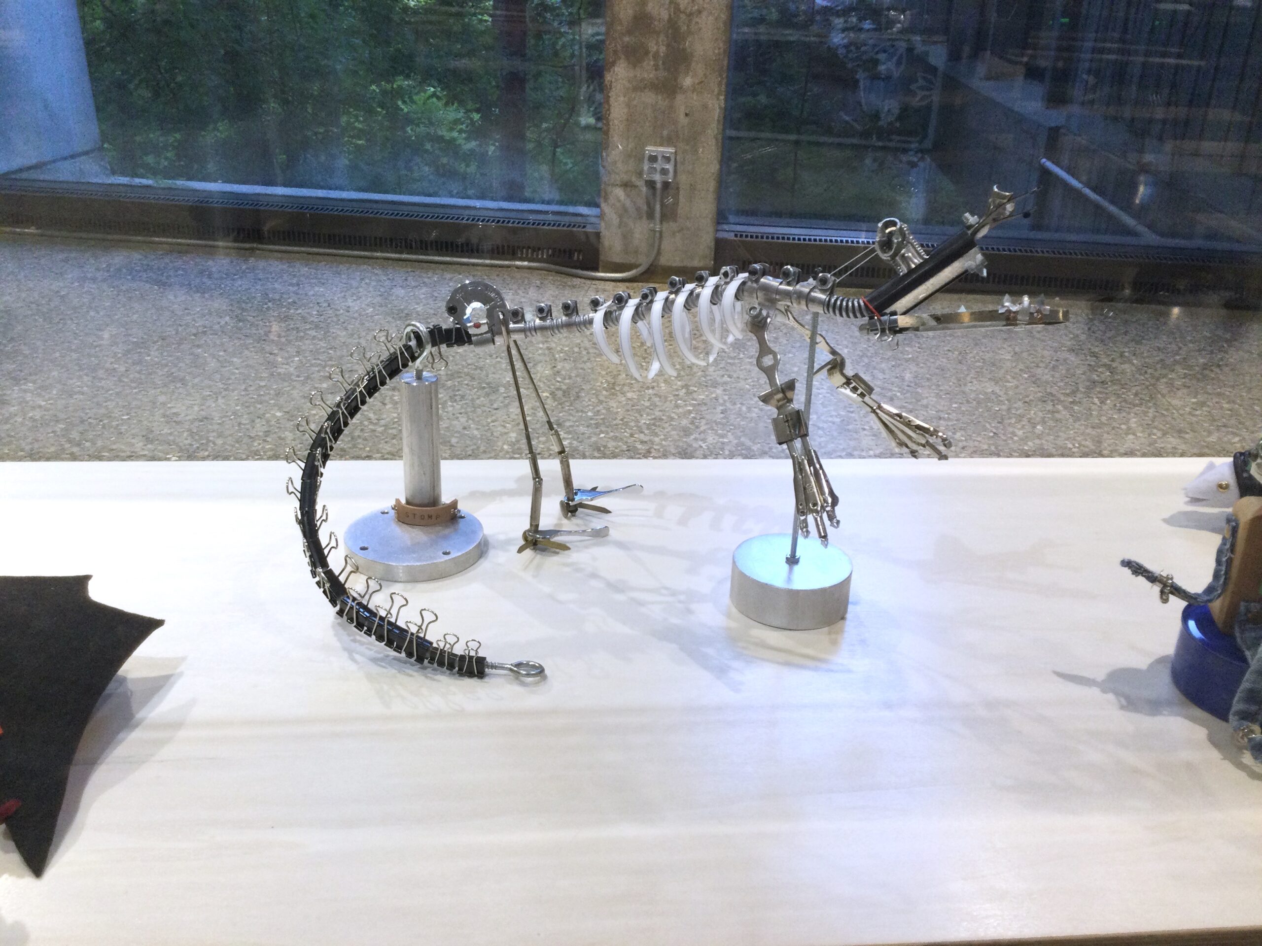 Scrap robot dinosaur in a display case at the Ontario Science Centre