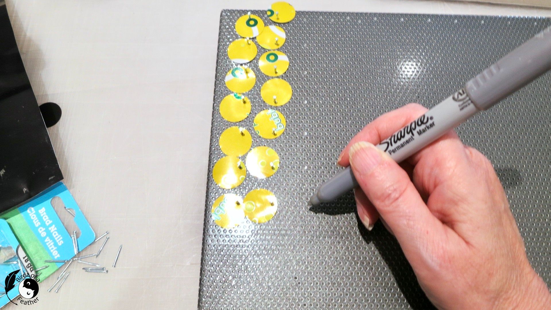 Marking the metal message board with a silver sharpie