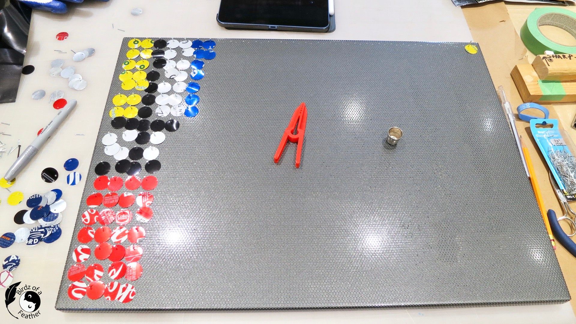 message board with circle punches installed on the left side for soda can craft