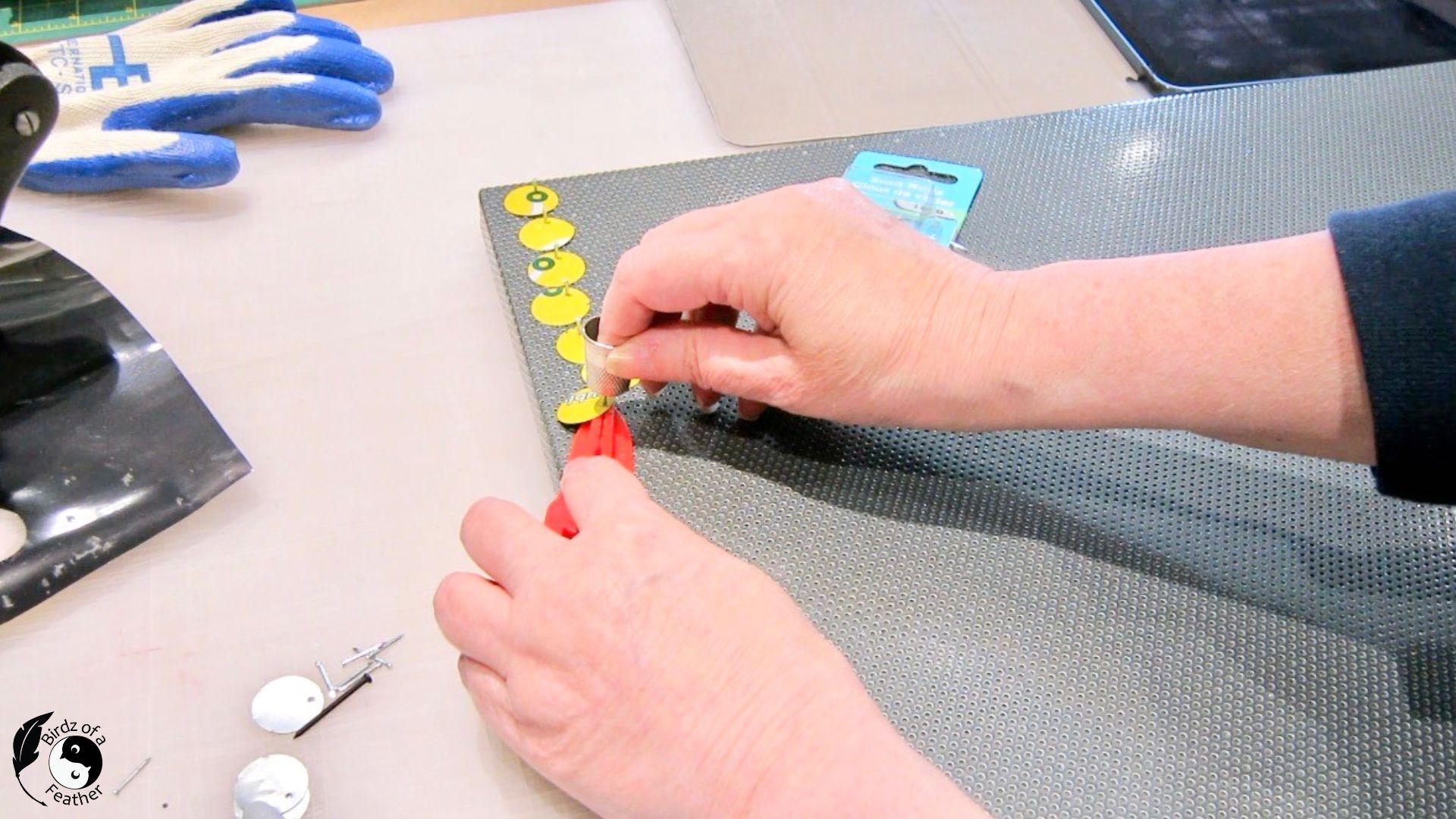 Using a thimble to push in brad nails for soda can craft