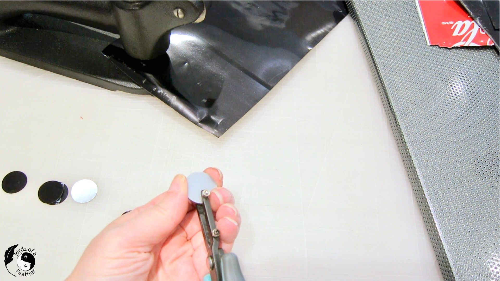 Circle template craft being use to punch nail holes