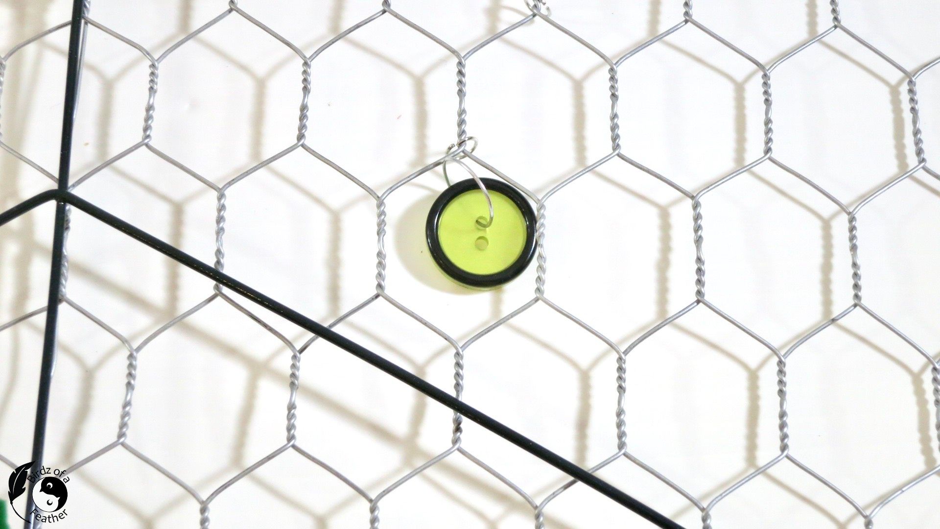 Button joined to chicken wire of suncatcher DIY