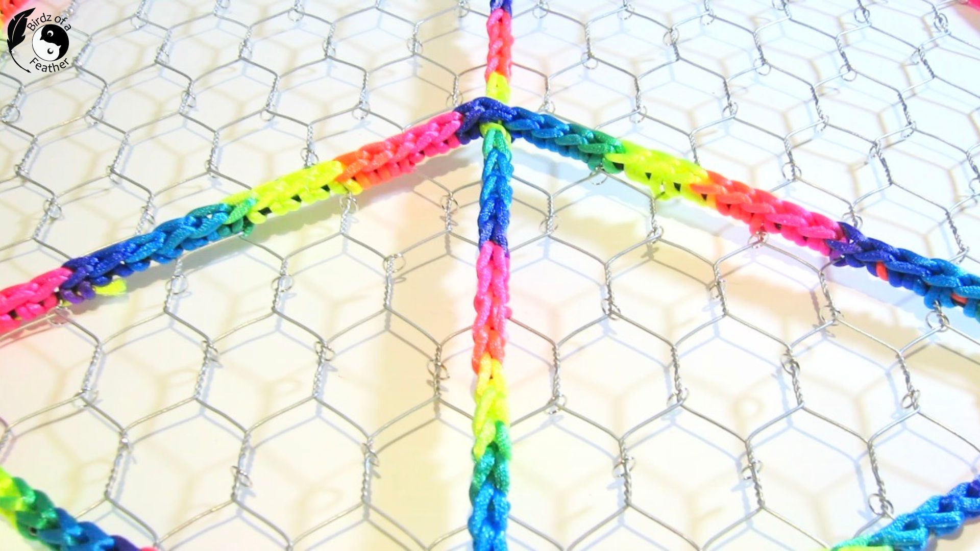 close up of jump rings attached to sections of chicken wire