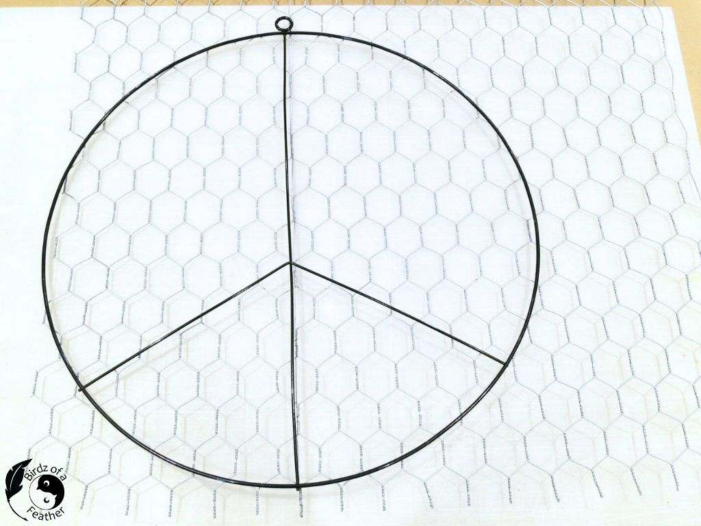 Chicken wire and wire peace sign make up the suncatcher DIY