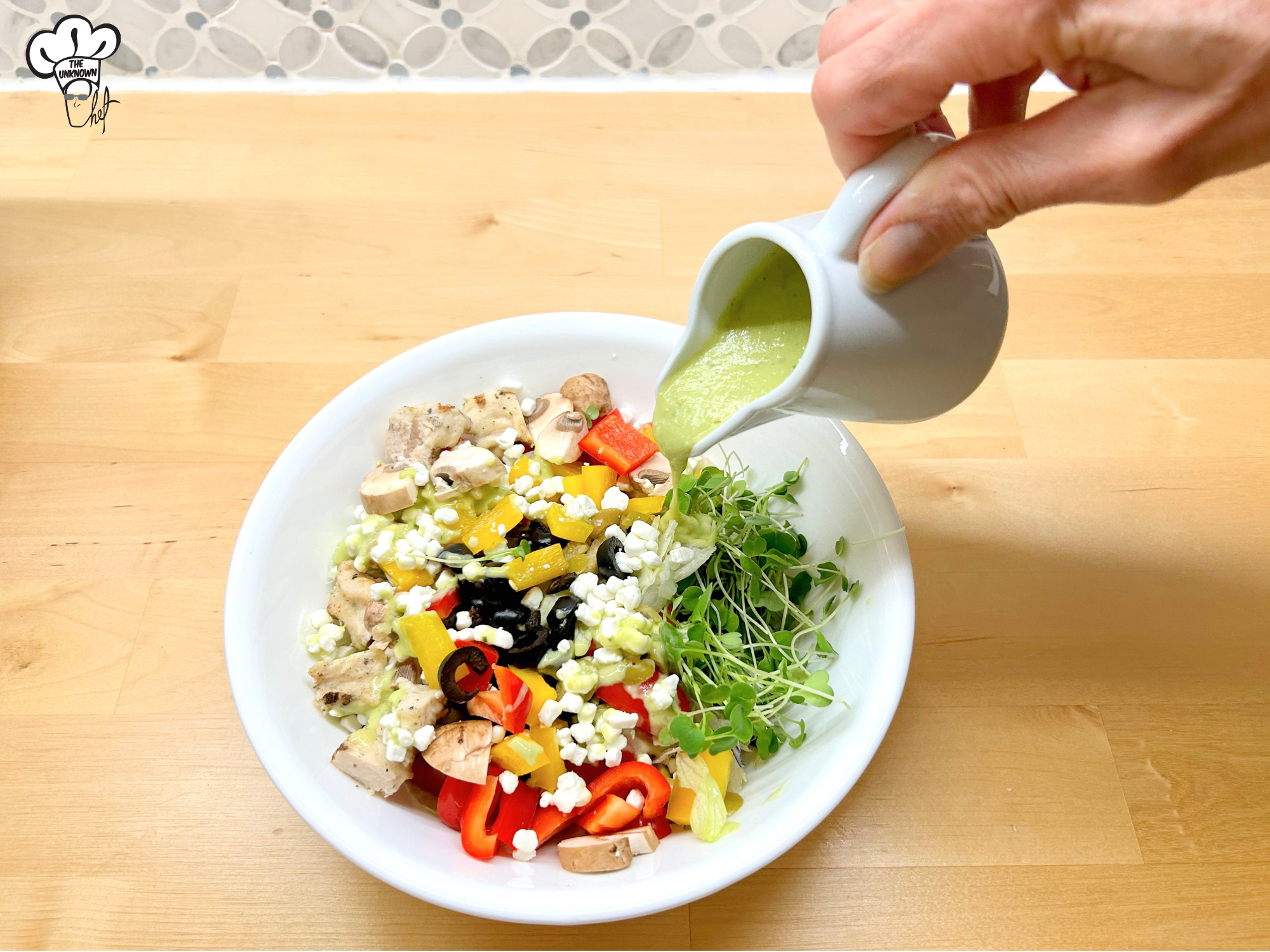 Green Goddess dressing recipe being poured onto a salad