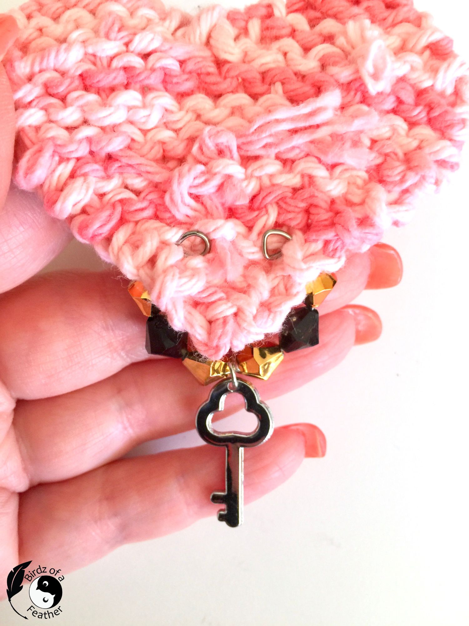 Back of knit heart with wine charm attached through back of DIY Charm Necklace