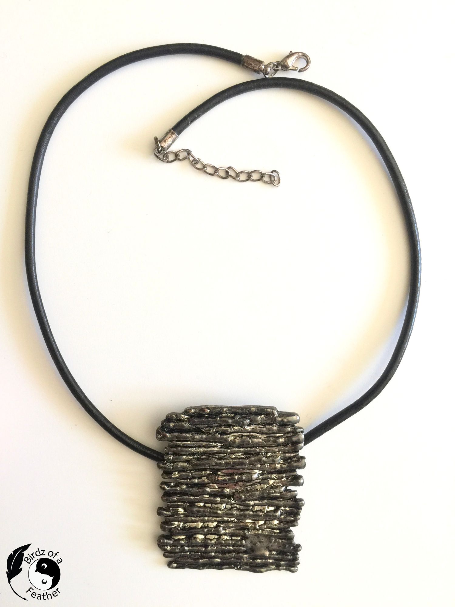 Metal necklace with leather cord