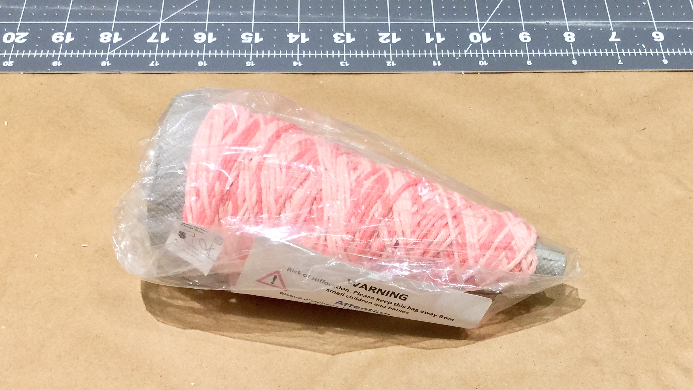 Cone of pink thrifted variegate yarn