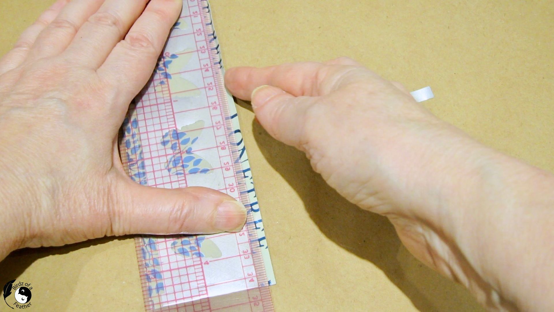 Using a ruler to help fold in the long edges of the soda can