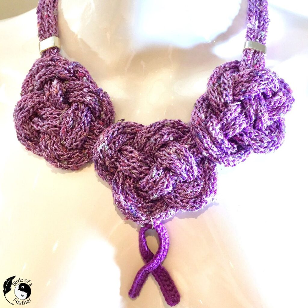 Crocheted Celtic Knot Necklace with a purple ribbon focal