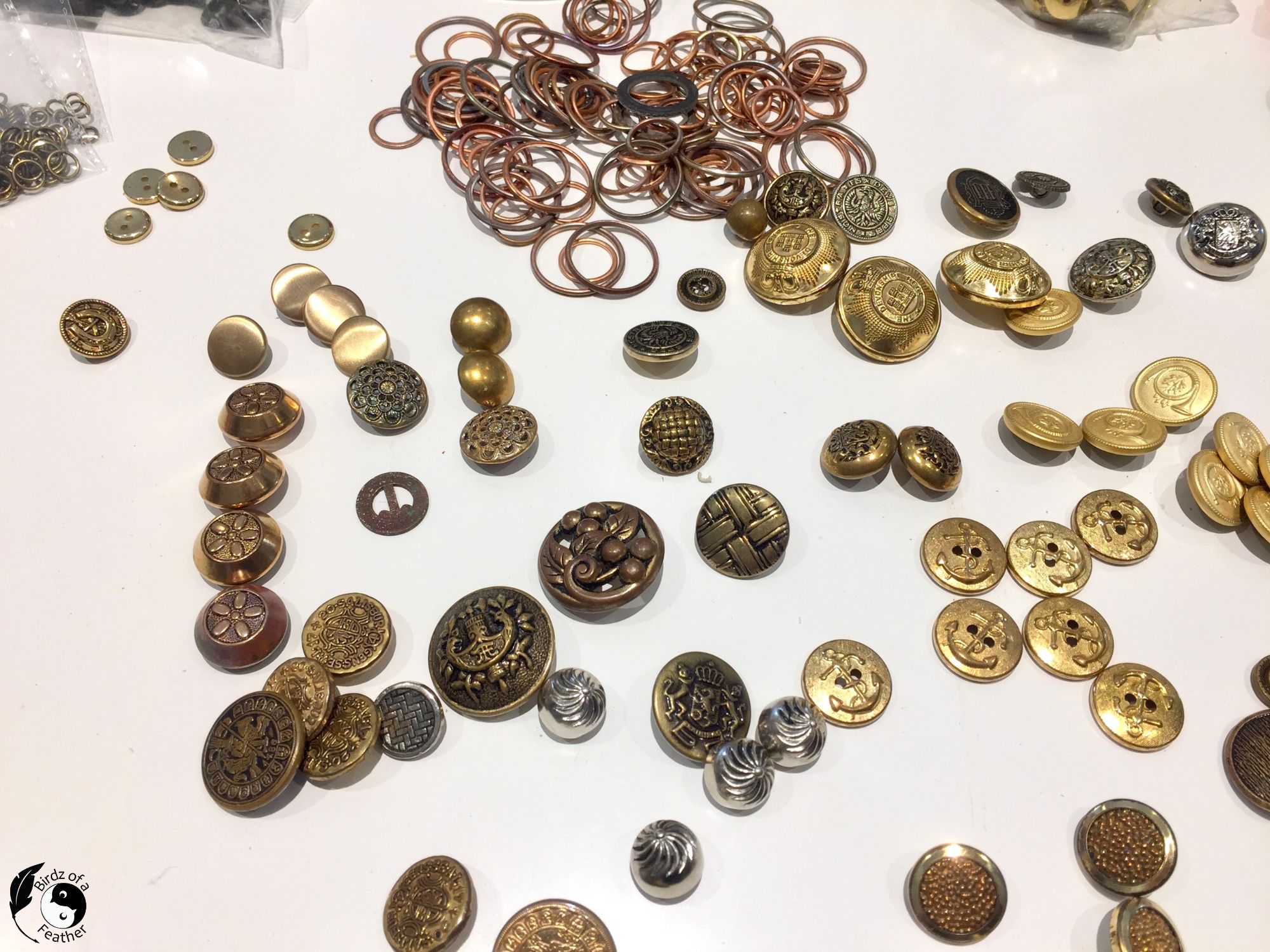Brass buttons and copper washers drying on paper towels after cleaning in the ultrasonic 