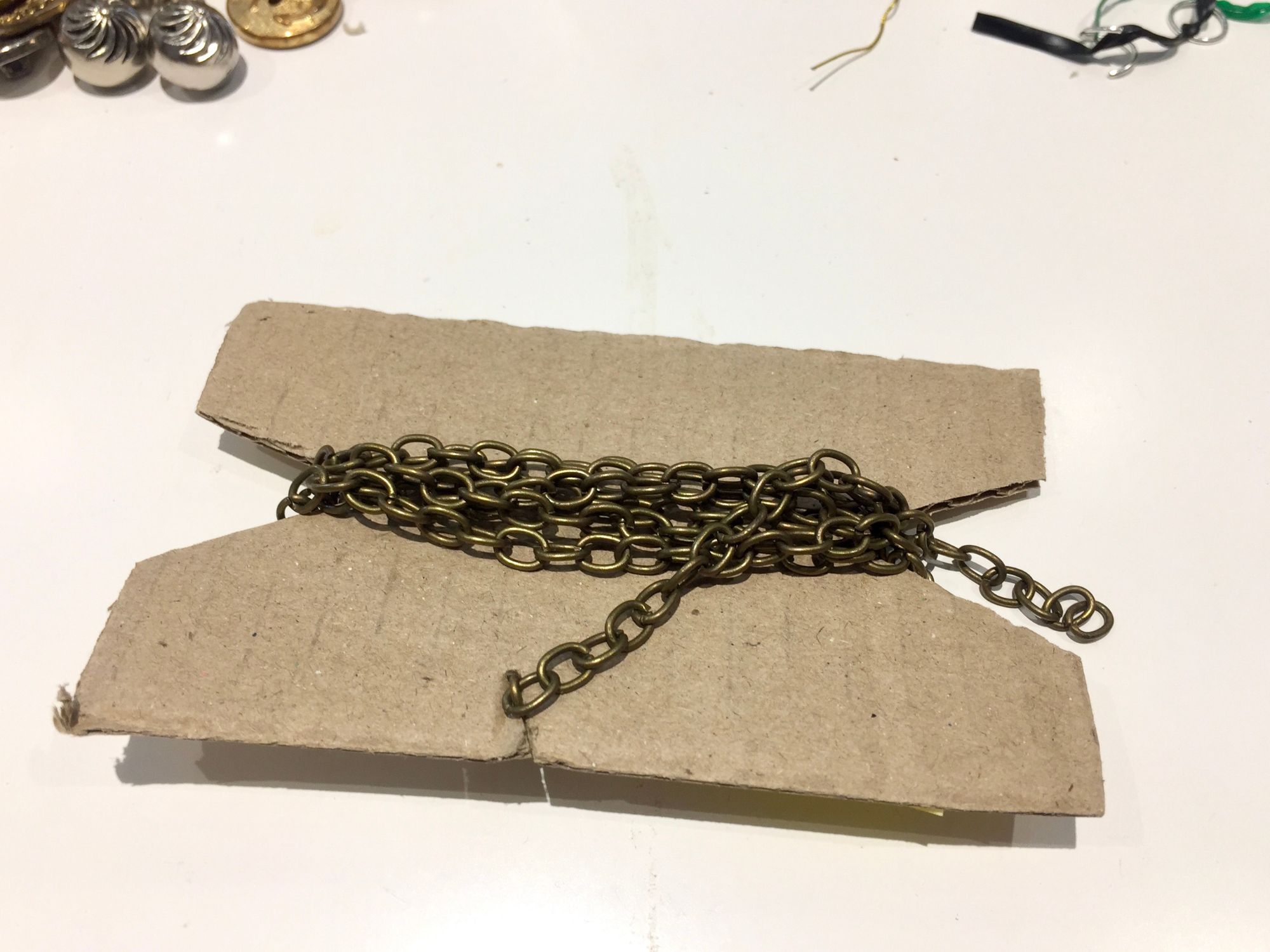 Antique brass chain wrapped around cardboard